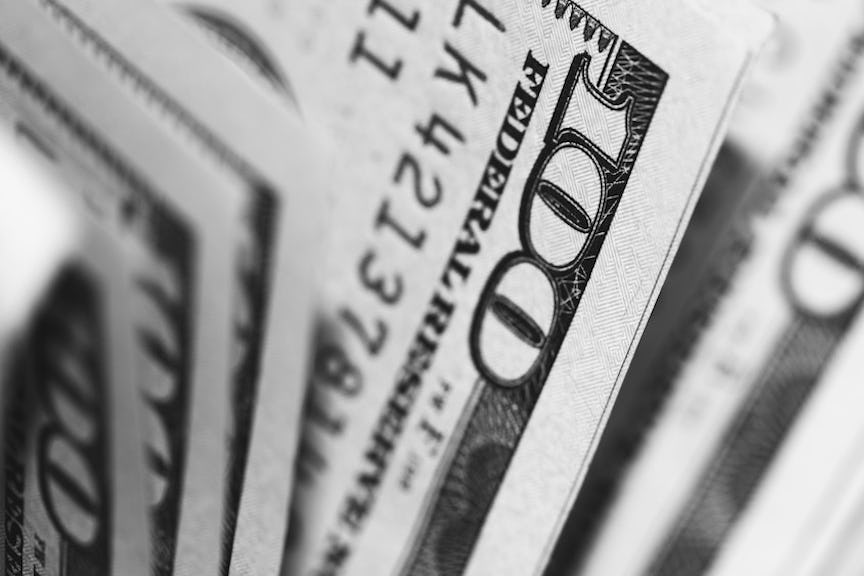 hundred dollar bills represent savings for reimburse employees for health insurance